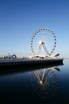 Giant Wheel Reflection in Harbor Water