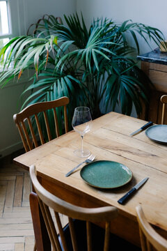 A wooden table in a rustic dining room in a Parisian loft