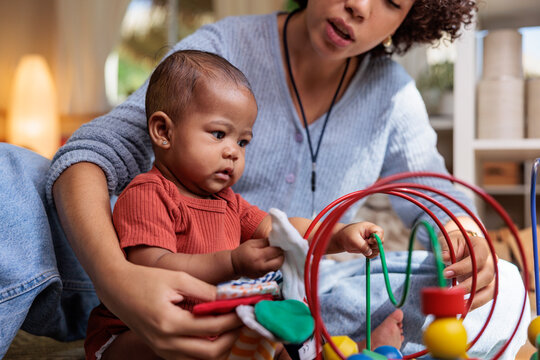 Mother and baby playing with toys.
