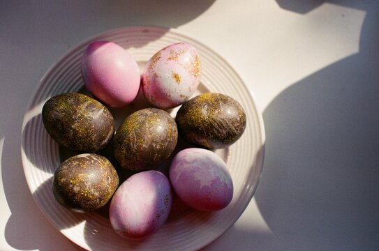 Multicolored colored eggs laid out on a plate