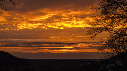 Dramatic layered sunset clouds over hills