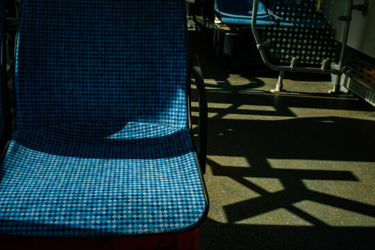 Chairs with blue checkered fabric in a sunlit public space