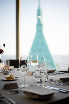 Elegant Dining Setup Overlooking a City Skyline at Sunset
