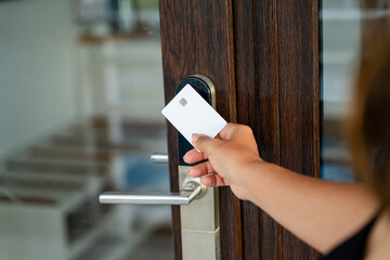 Woman using key card to open door