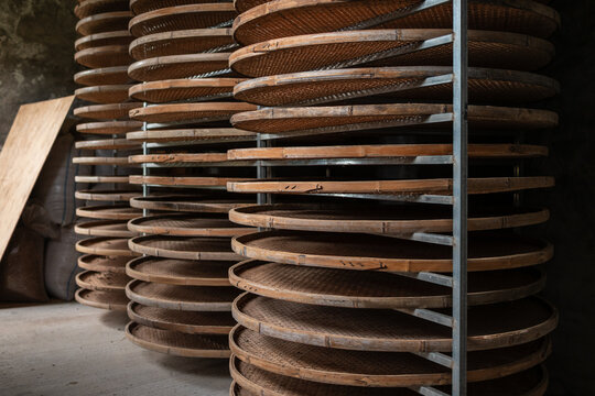 Circular Wooden Racks for Drying Food in a Rustic Storage Area