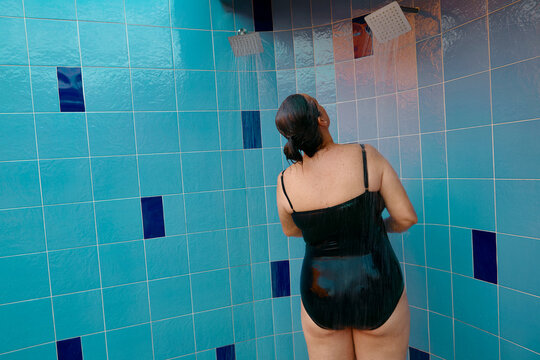 Woman showering at pool facility