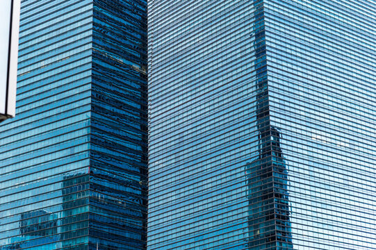Corporate blue glass building repetition and architectural reflection