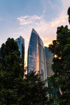 Financial glass towers glowing in atmospheric golden dusk