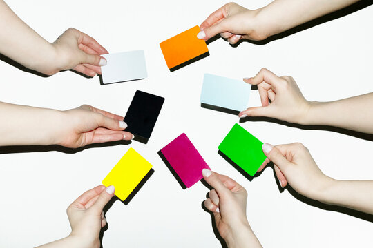Hand holding many colourful finance money payment credit debit cards 