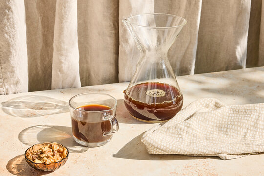 Coffee in a glass with snacks around 