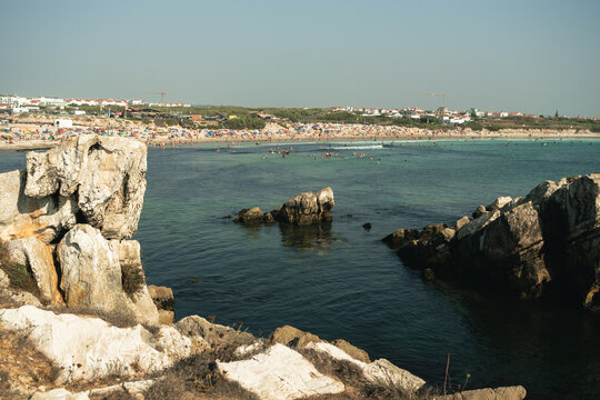 Rocky Coastline and Busy Beach Scene