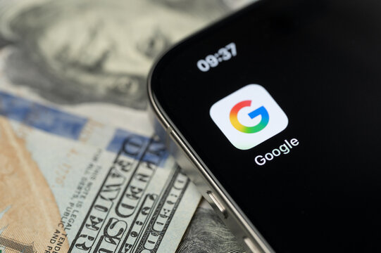 Google app on smartphone screen with dollar background