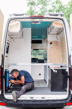 Man Installing Electrical System in Camper Van