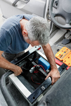 Inspecting Electrical Compartment in Camper Van