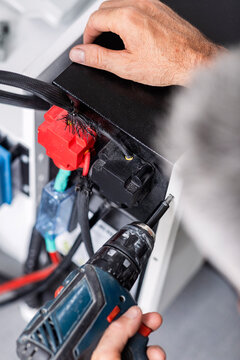 Man Installing Electrical Equipment in Camper Van