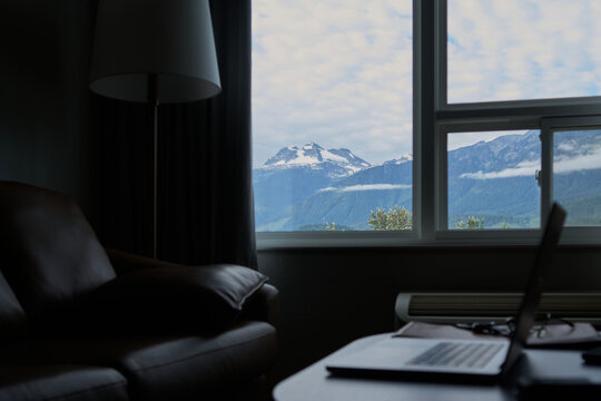 Fototapeta Mountain view through hotel window with workspace