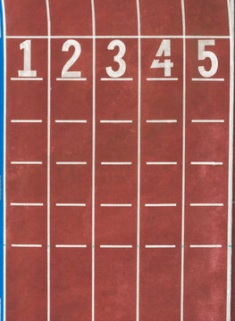 Overhead View of Numbered Lanes on Red Running Track Ground