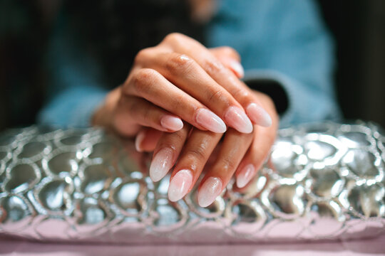 Close-up of freshly done almond-shaped ombre nails