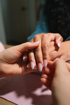 Close-up of gel manicure final touches with ombre nails