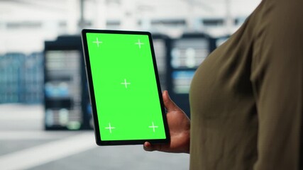 Server room admin uses isolated screen tablet to increase supercomputers workload capacity. Data center worker configures gear with chroma key device notebook, improving processing speed, camera B - Powered by Adobe
