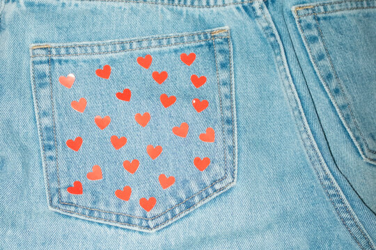 Close up of blue denim jeans with pocket with heart shaped pattern