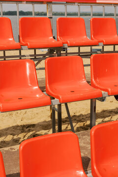 Bright Orange Seats Await Spectators at a Riverside Event