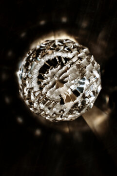 Intricate Crystal Orb Capturing Light in a Dark Setting
