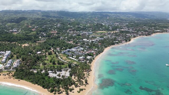 Wide aerial capture of Punta Popy Beach &mdash; tropical palms, pristine beach, and turquoise sea. Ideal for property marketing.