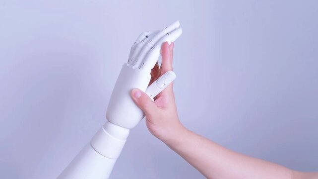 Human and robot hands touching