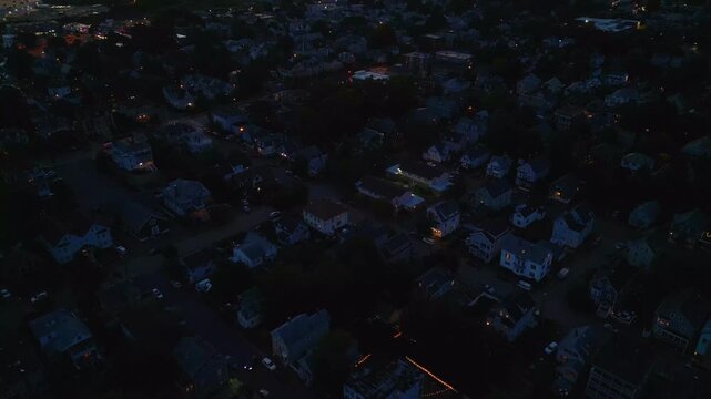 Aerial view of Salem Massachusetts at night with street lights turned on 