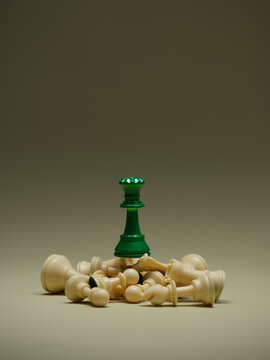 A green queen reigns supreme over defeated white chess