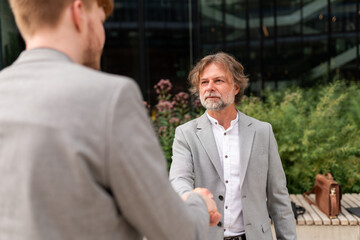 Business Professionals Shaking Hands in an Urban Setting