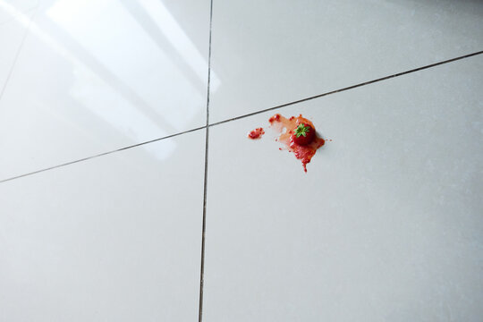 Strawberry smashed on White Tiles Creates a Vibrant Mess wide shot
