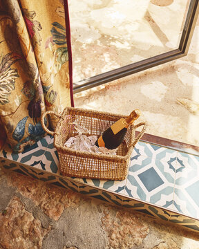 Elegant Basket With Champagne and Glasses by the Window
