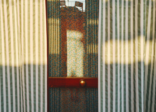 Sunlight Filtering Through Striped Curtains in a Cozy Room