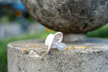Baby Pacifier on Concrete Surface Outdoors