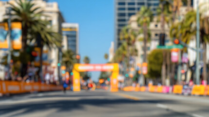 Blurred urban street scene with marathon finish line arch and palm trees