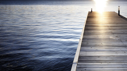 Wooden dock extending into calm water at sunrise