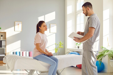 Consultation for manual therapy rehabilitation, massage, male physical therapist in therapy medical clinic room. Female patient med coach sitting to reduce disability, pain, get body health, wellness