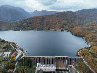 Aerial view of Perucac dam on Drina River near Tara National Park in Serbia, surrounded by autumn forest. C