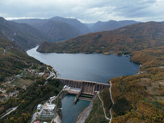 Aerial view of Perucac dam on Drina River near Tara National Park in Serbia, surrounded by autumn forest. C