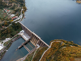 Aerial view of Perucac dam on Drina River near Tara National Park in Serbia, surrounded by autumn forest. C