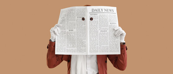 Female spy looking through newspaper on beige background