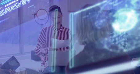 Woman in striped red shirt analyzing data overlays in office lounge, with laptop at meeting table