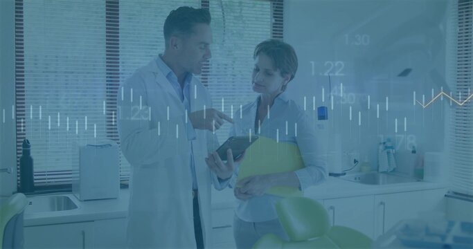 Pointing doctor and patient examining tablet data in medical consultation room, with yellow folder