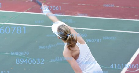 Tennis player in visor serving ball with racket on hard court lines, with numeric overlay