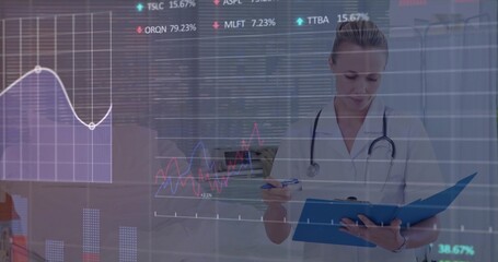 Doctor wearing stethoscope analyzing writing on blue clipboard in clinic with data chart overlays