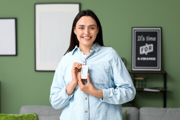 Diabetic young woman with glucometer at home