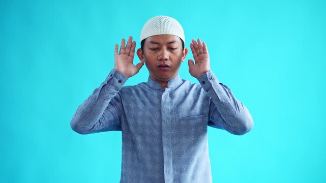 Muslim man doing takbiratul ihram expressing faith and devotion with traditional attire