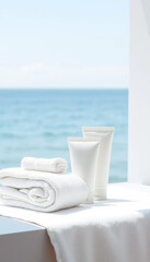 Minimal skincare tubes with towels in bright coastal sunlight